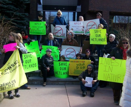 Niagara area residents demonstrate before Niagara Falls council meeting on wetland "offsetting" scheme.